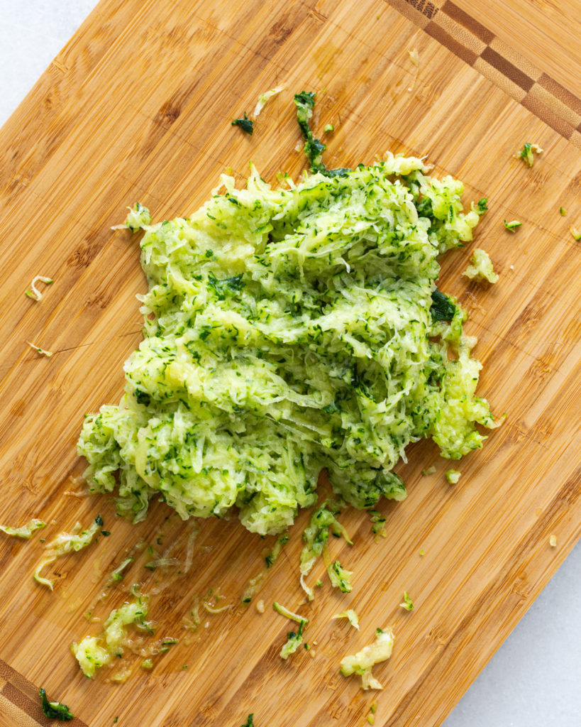 grated zucchini on a cutting board.