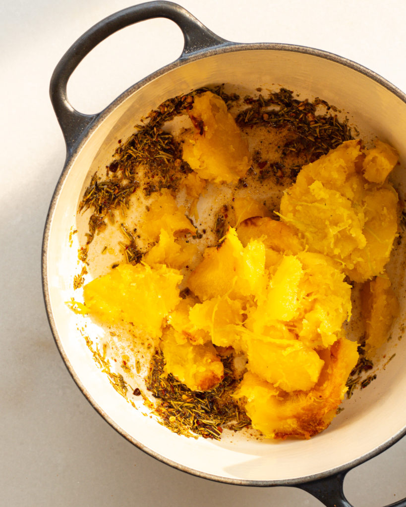 Mashed butternut squash and seasonings in pot