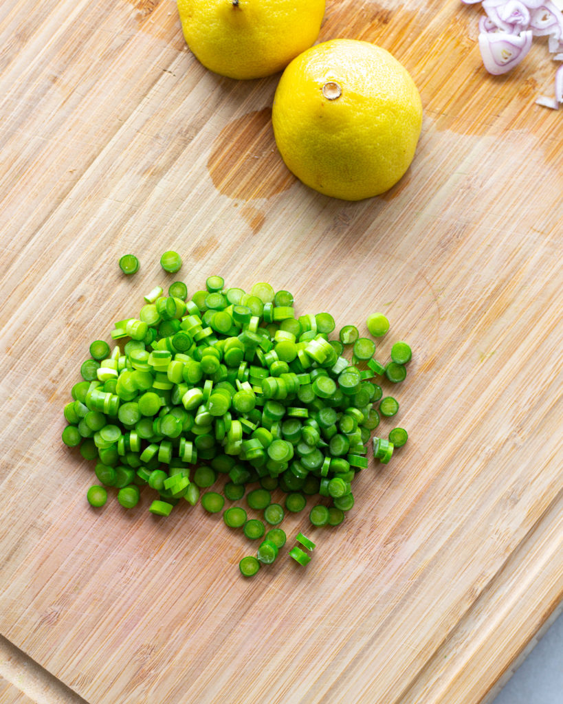 Sliced garlic scapes, halved lemon