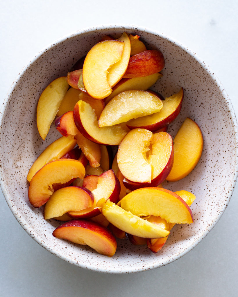Sliced peaches in bowl