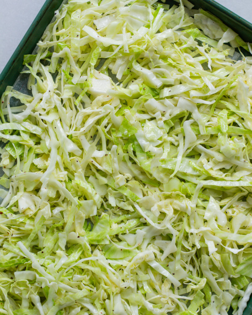Seasoned green cabbage on baking sheet