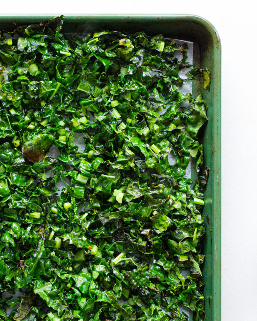 Seasoned kale on baking sheet