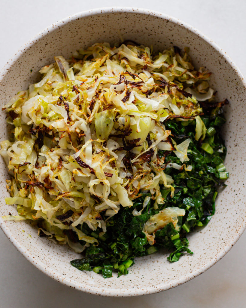 Baked cabbage and kale added to bowl