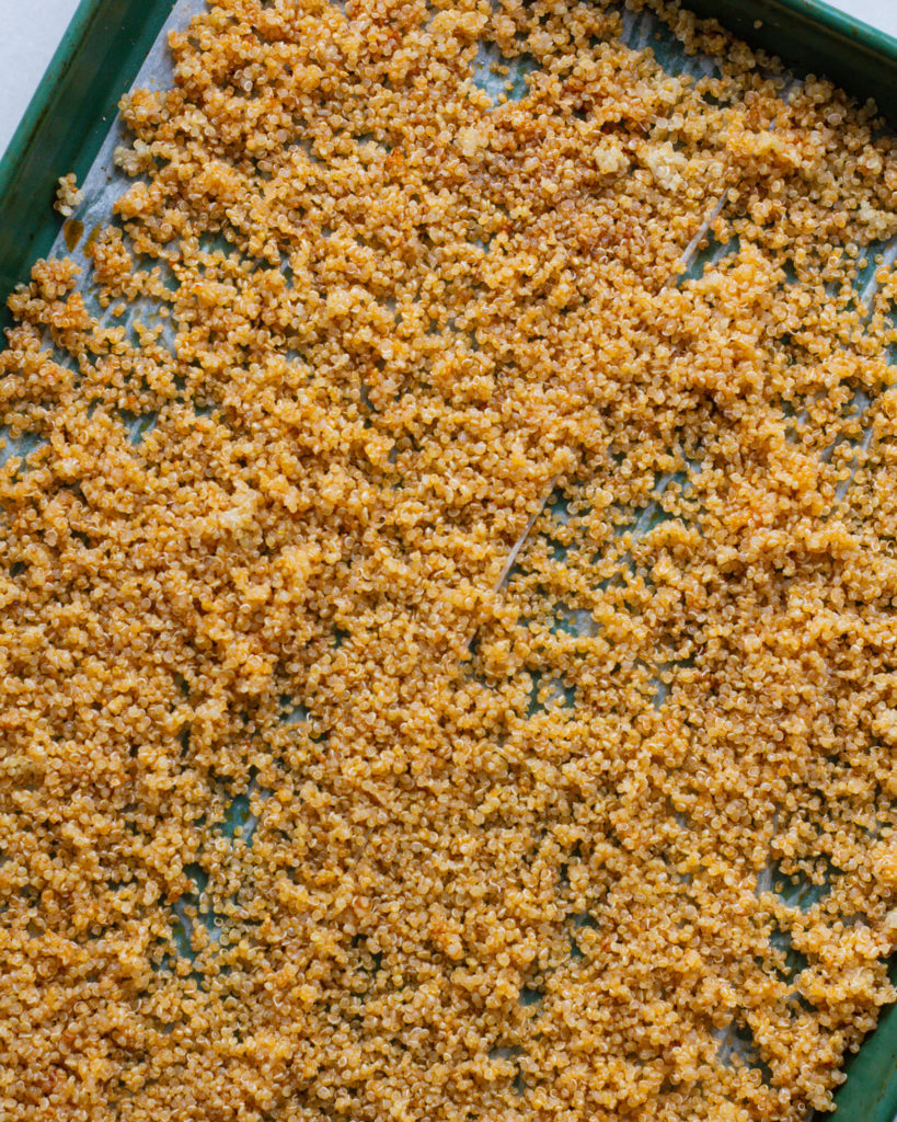 Cooked quinoa on baking sheet