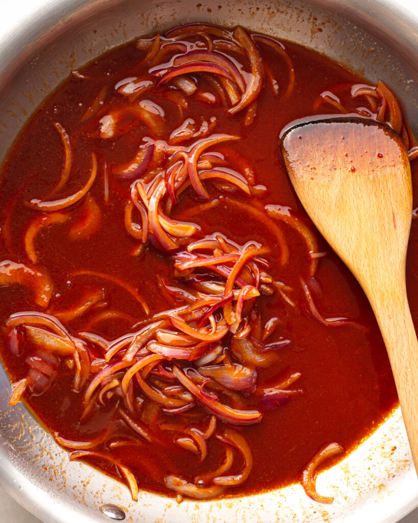 Gochujang sauce and onions in pan