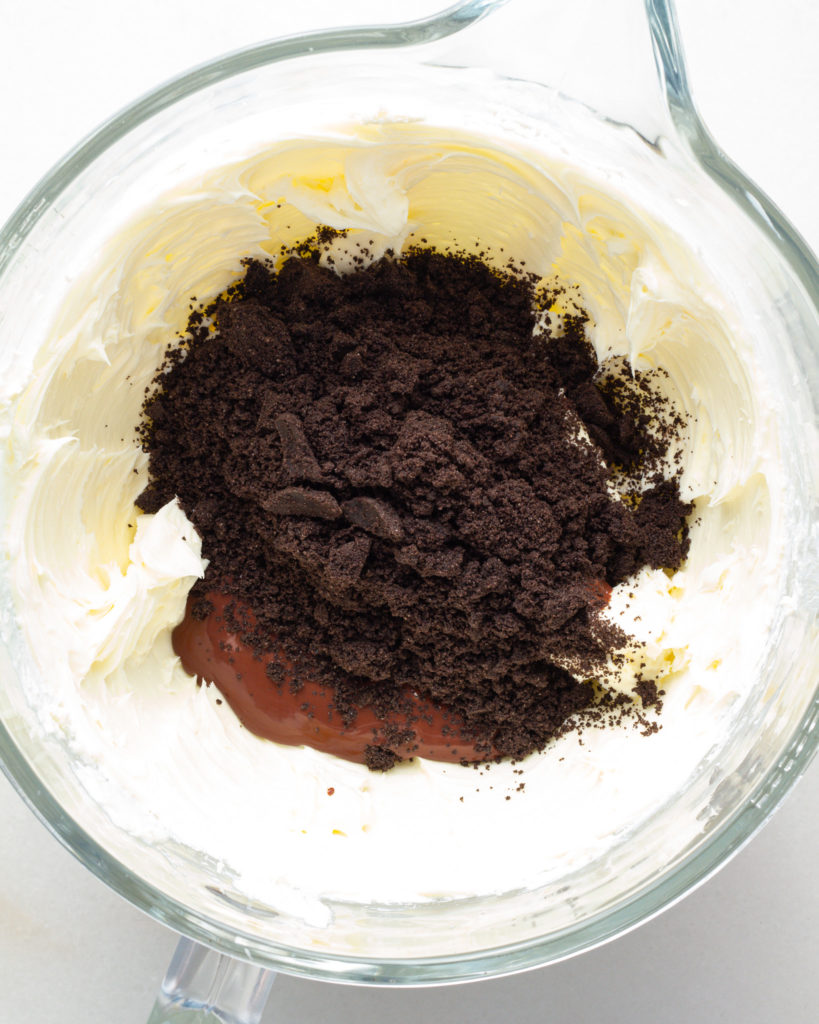 Chocolate, oreo crumble, and cream cheese in bowl