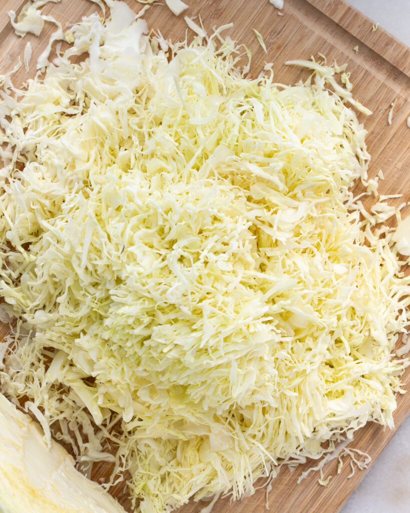 finely cut green cabbage on a cutting board