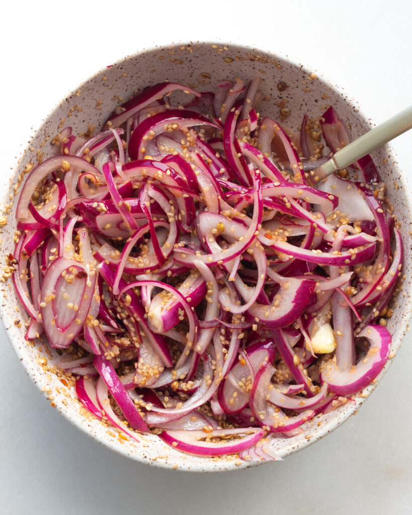 Sesame and honey red onions in bowl