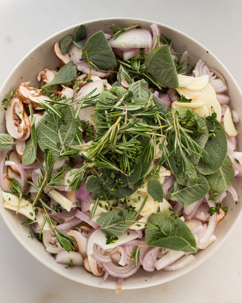 herbs, shallots, mushrooms and other ingredients in bowl