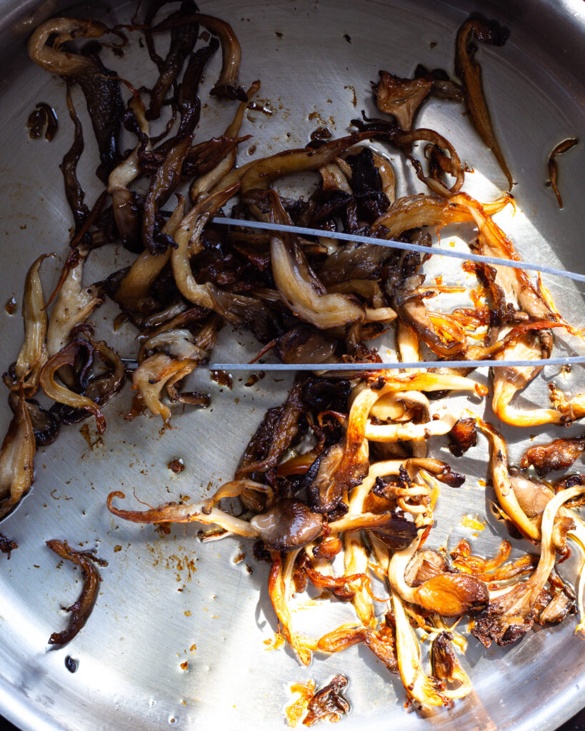 oyster mushrooms being made crispy in a pan