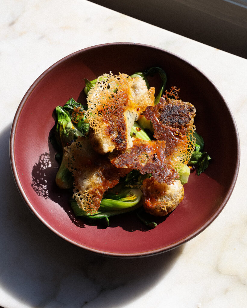 a plate of edamame dumplings in rice paper wrappers