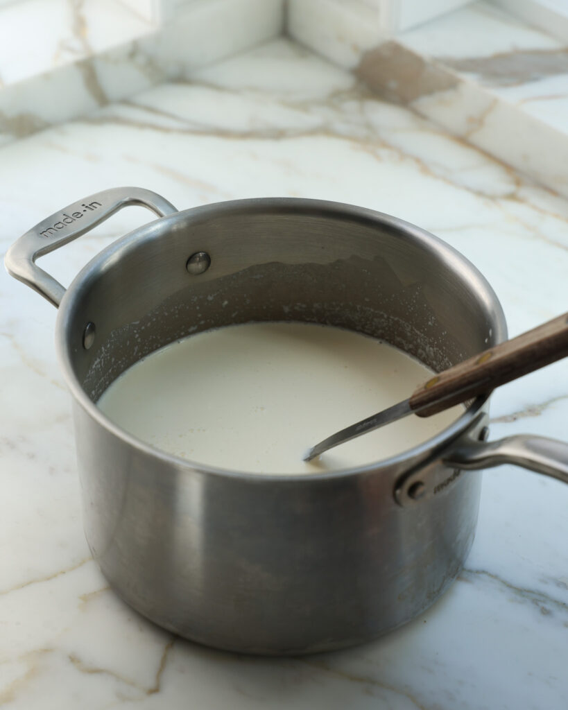 mixing and cooking an ice cream base in a pot
