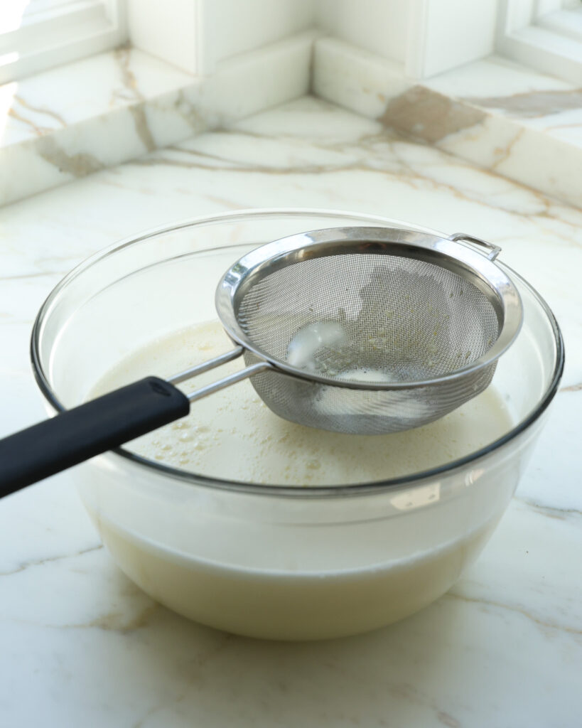 straining out an ice cream custard base