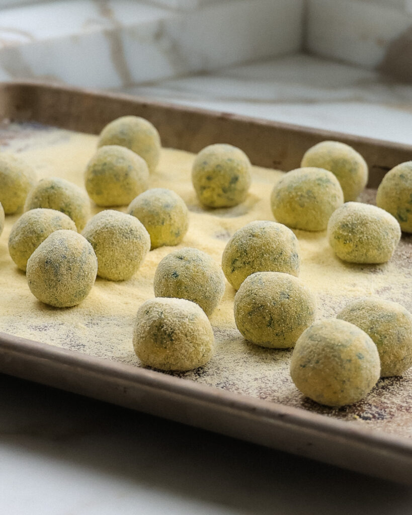 Rolled up spinach gnudi ready to be cooked