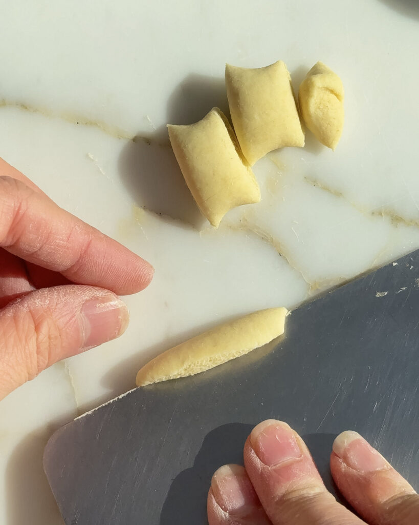 shaping homemade orecchiette by hand.