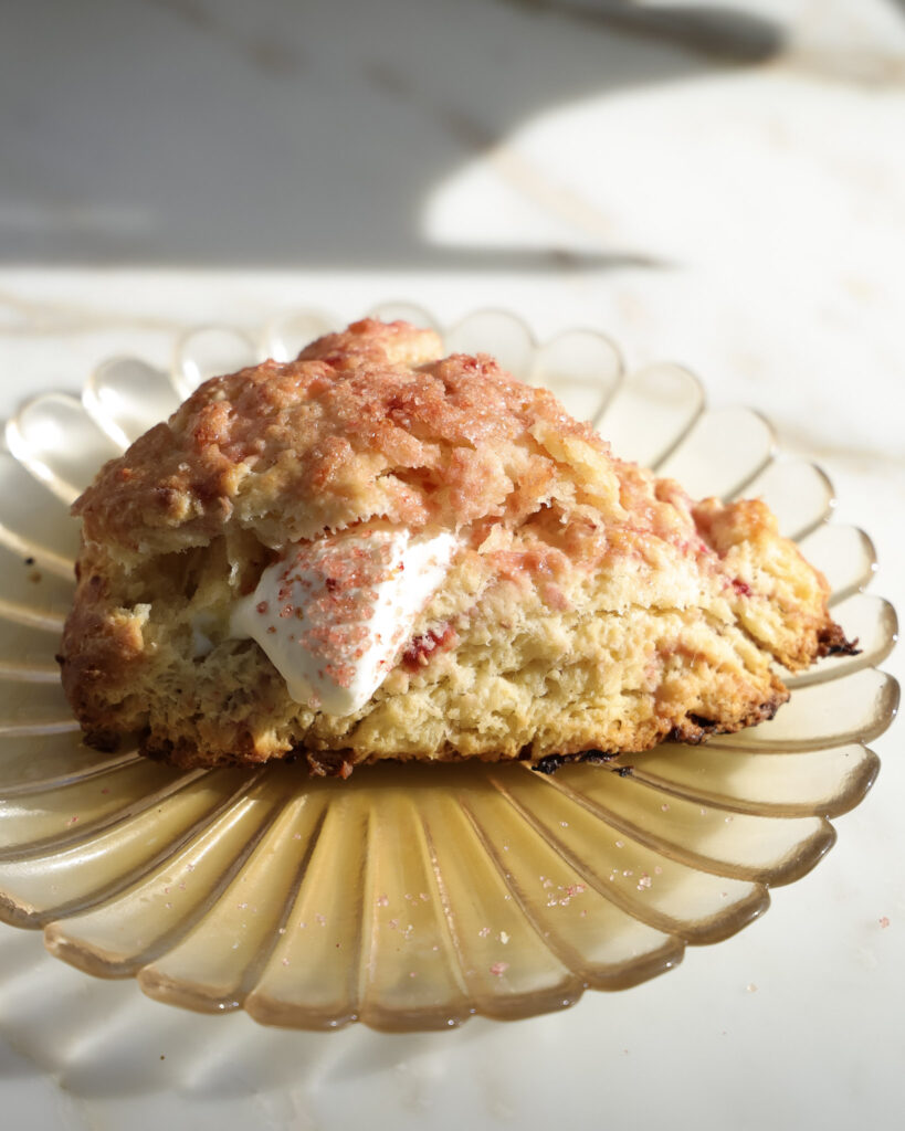 berry scone topped with pink sugar.