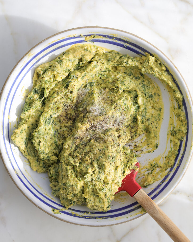 Mixing the gnudi dough in a bowl.