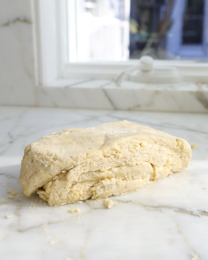 scone dough divided and stacked on top itself.