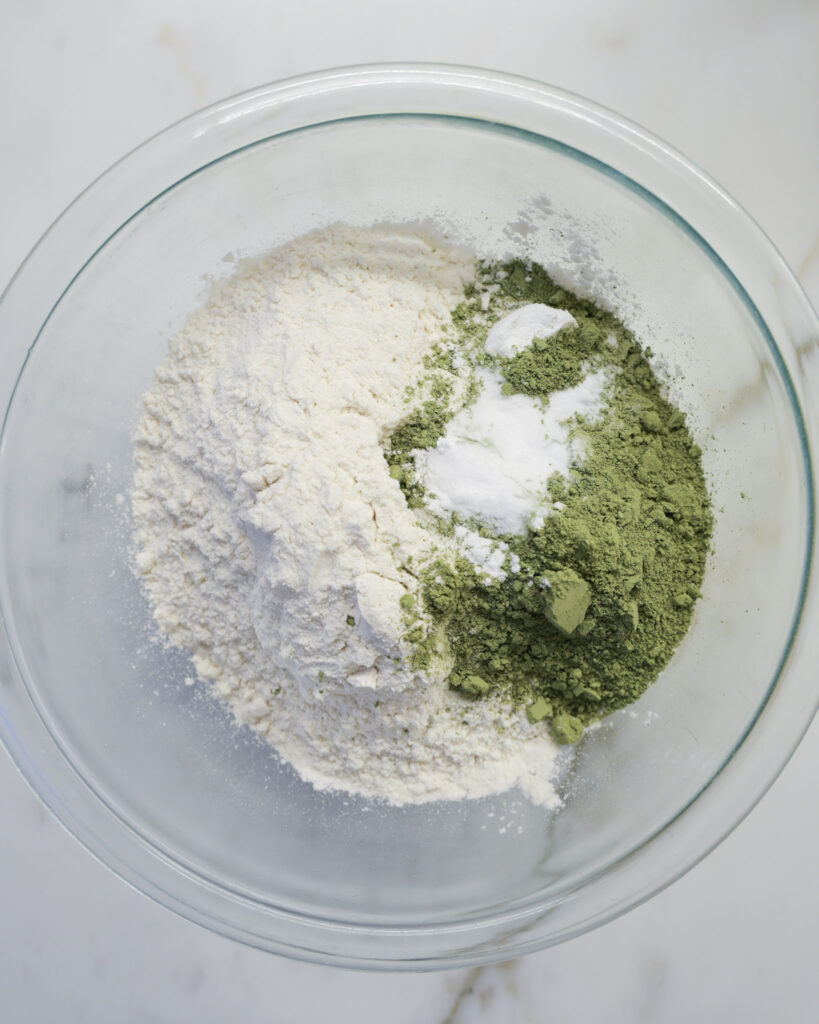 Dry ingredients for matcha cookies in a bowl.