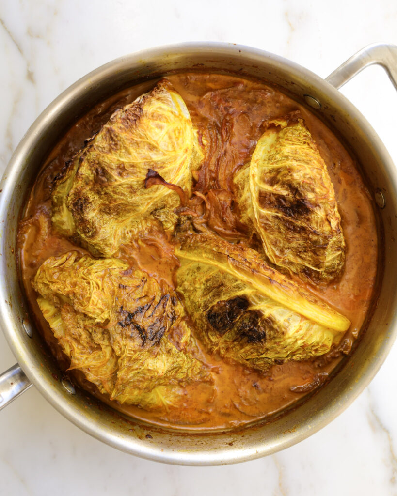 Seared cabbage wedges that have been roasted in braising liquid.