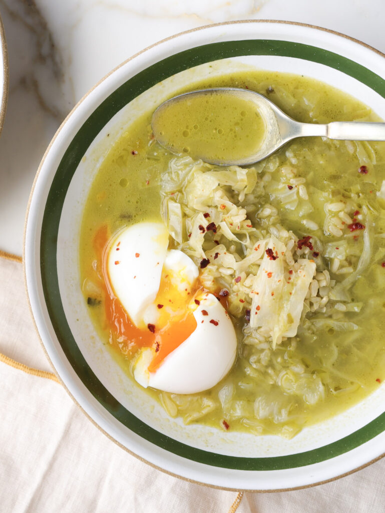 ramp soup in a bowl topped with a soft boiled egg.