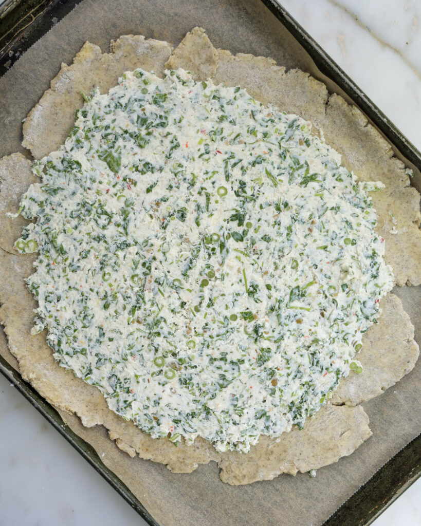 goat cheese mixture spread across pie crust.