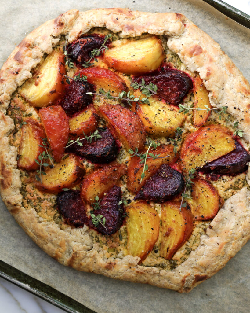 Beet tart topped with fresh thyme.