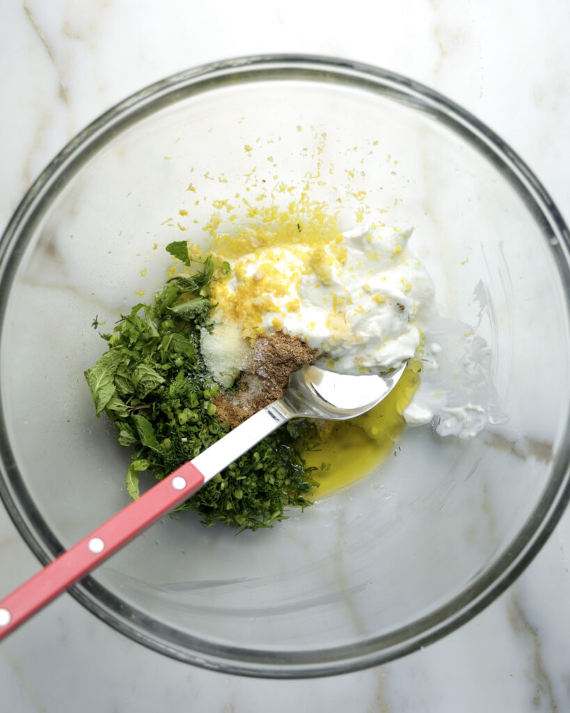 yogurt, olive oil and spices in a bowl.