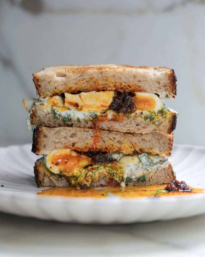 Çilbir sandwich halved and stacked.