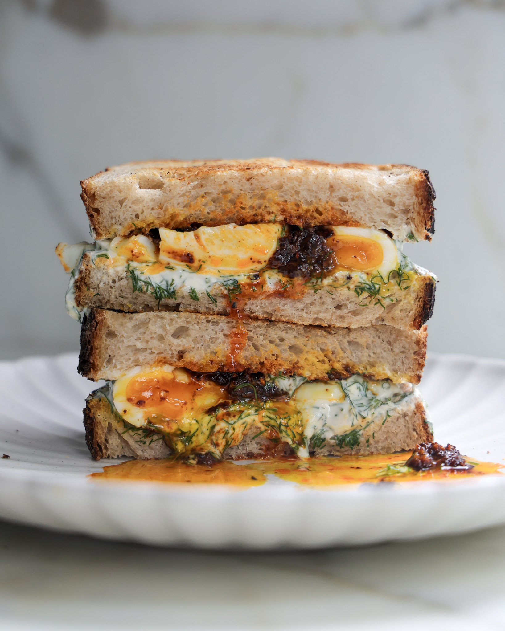 Çilbir sandwich halved and stacked.