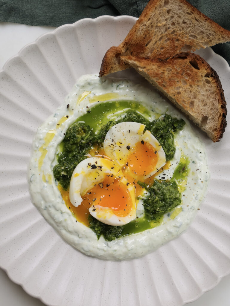 Soft boiled eggs over green sauce and skyr