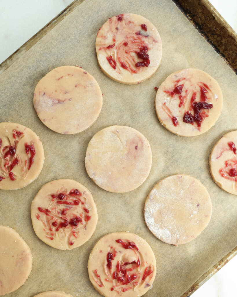 Cookie dough with jam swirled on top.