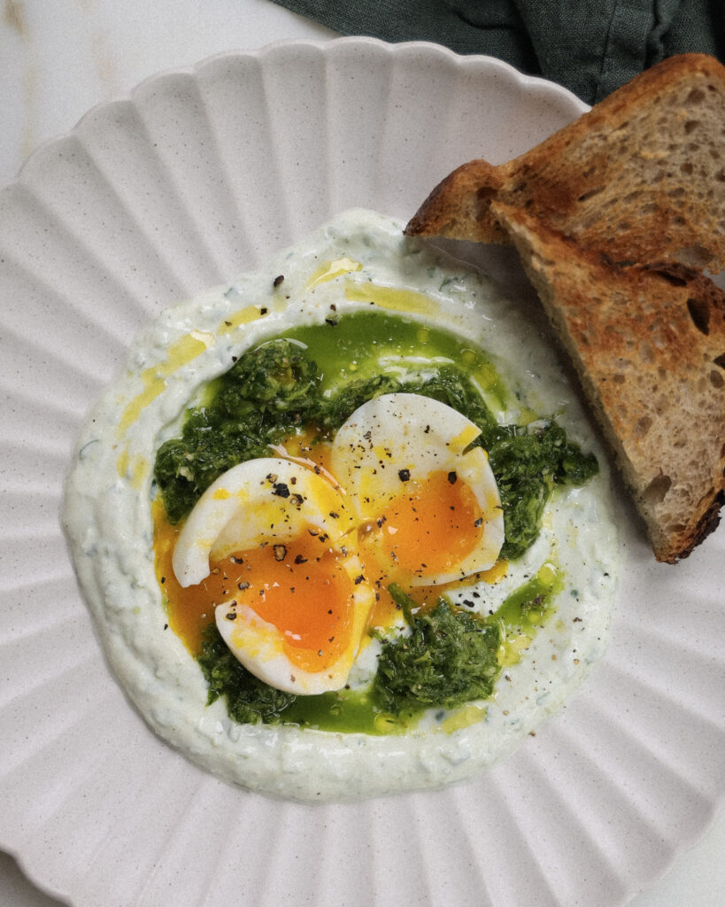 Soft boiled eggs over green sauce and skyr