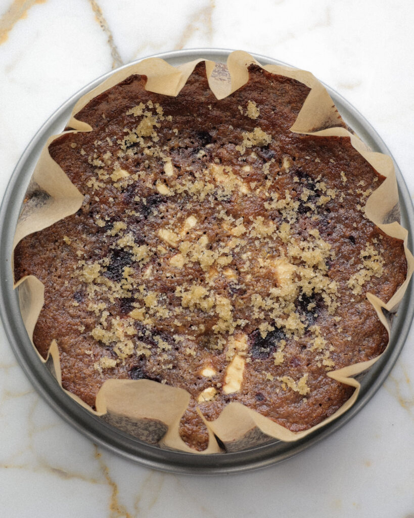 Blueberry brownie topped with white chocolate and turbinado sugar.