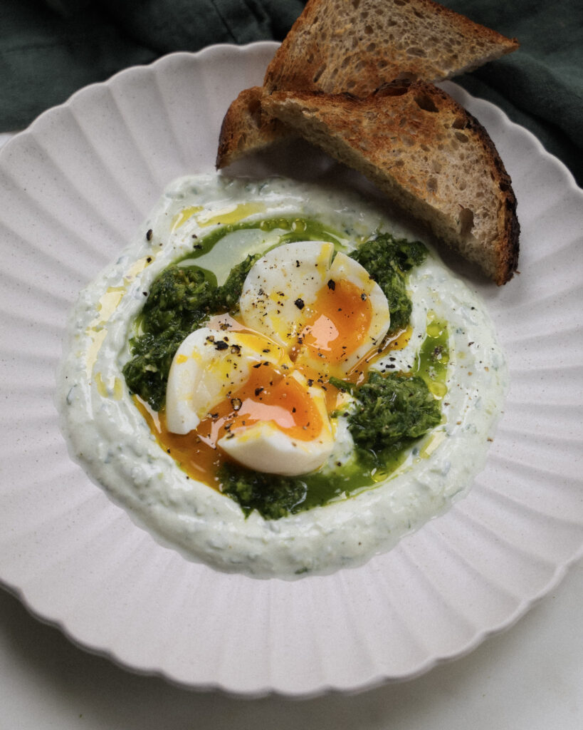 Soft boiled eggs over green sauce and skyr