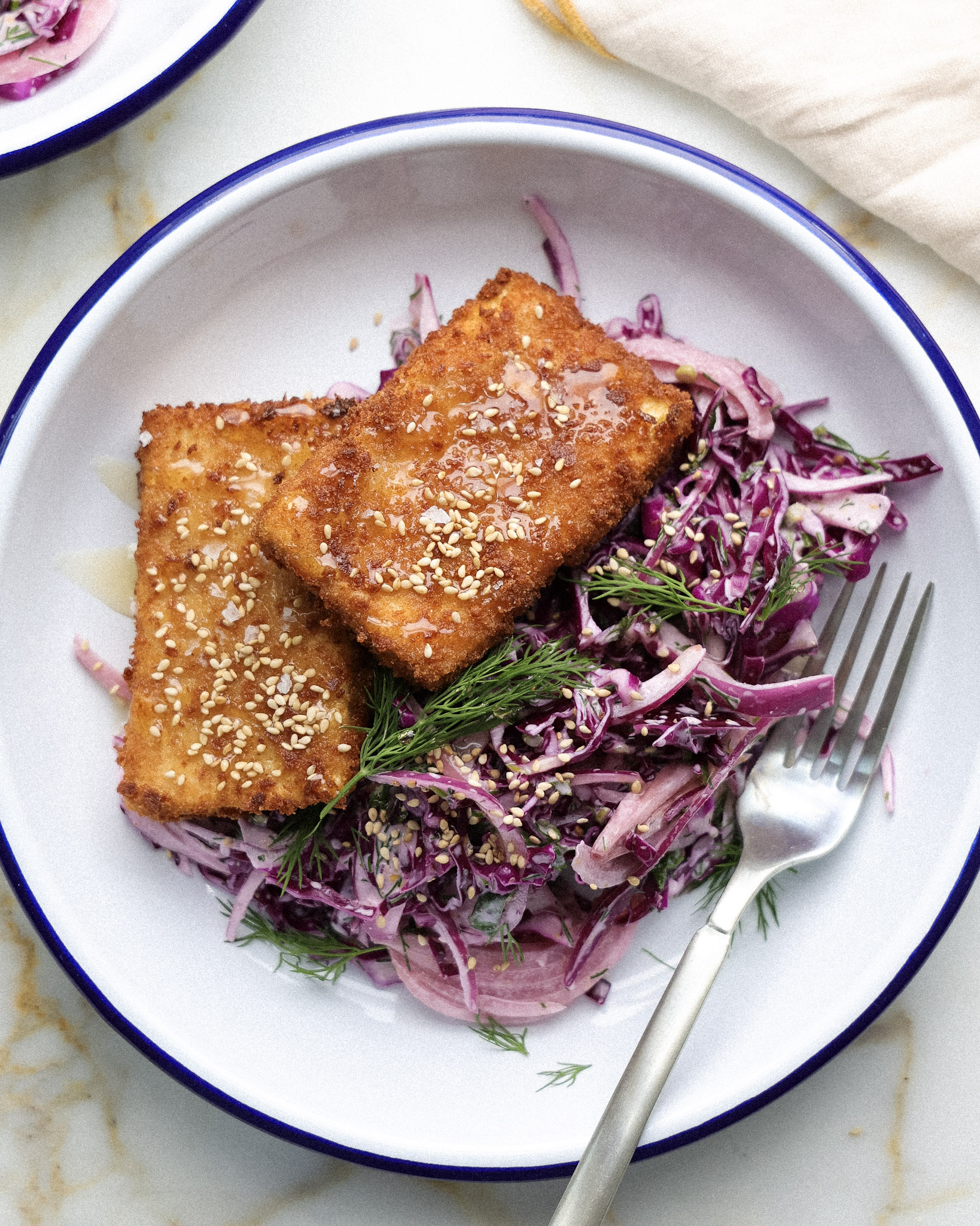 Tofu cutlets over cabbage slaw.