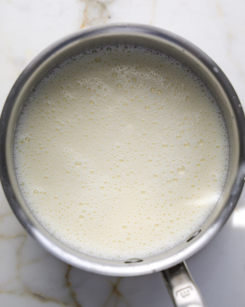 milk, sugar and heavy cream being warmed in a pot