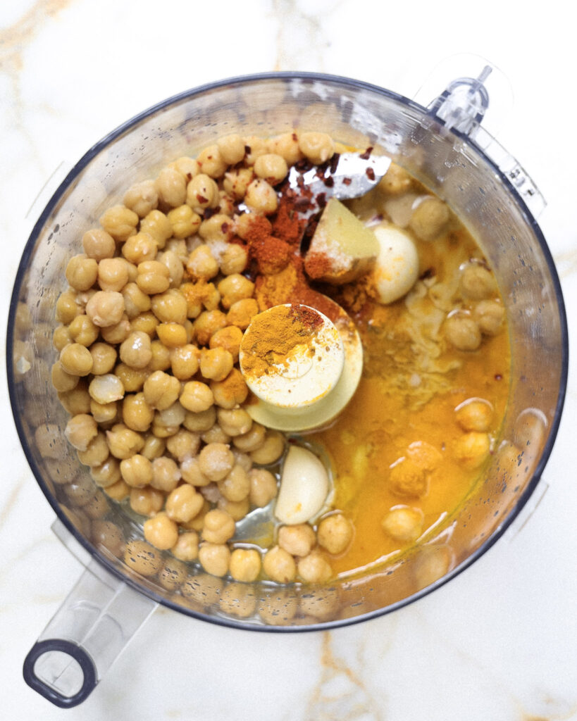 ingredients for golden hummus added to a food processor.