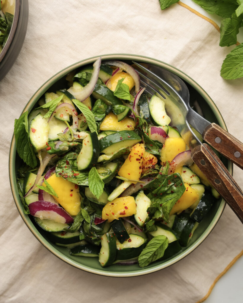 Cucumber and mango salad in a bowl.
