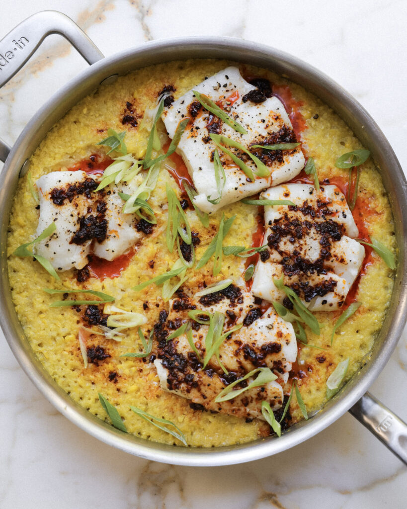 Cod filets placed over miso corn rice topped with scallions and chili crisp.
