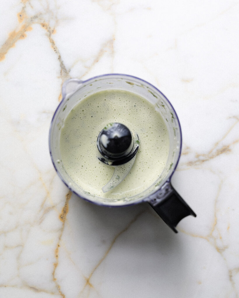 Basil dressing in a food processor.