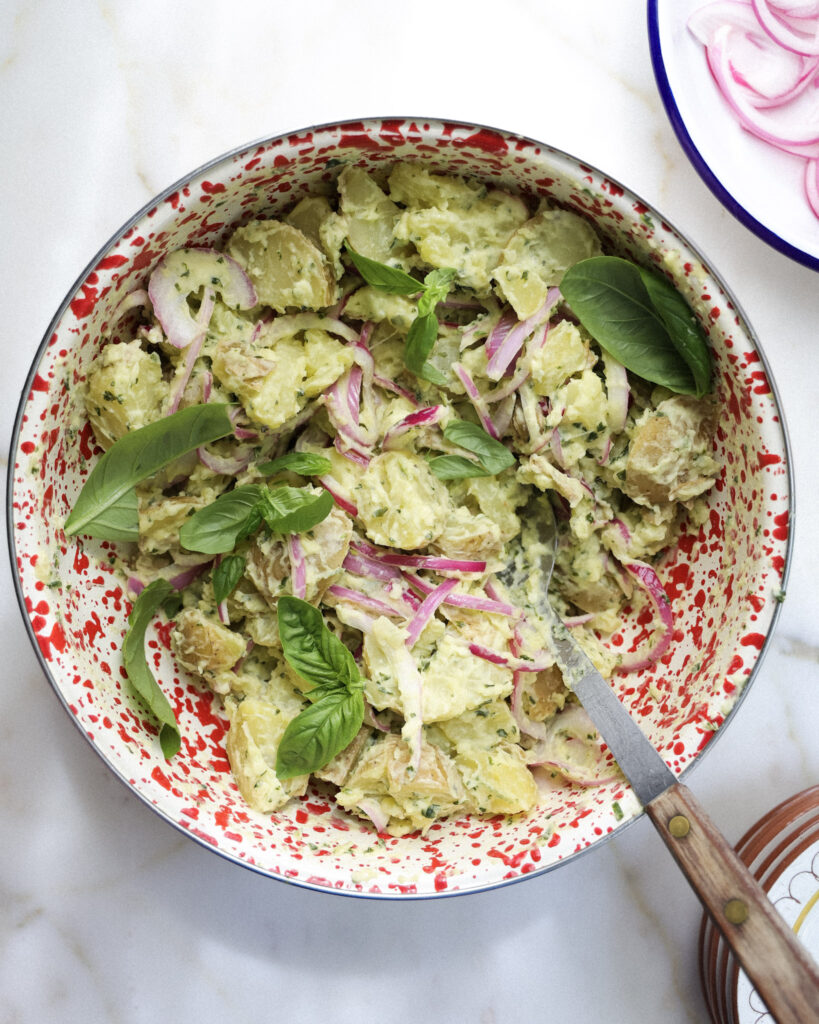Basil potato salad in a bowl.
