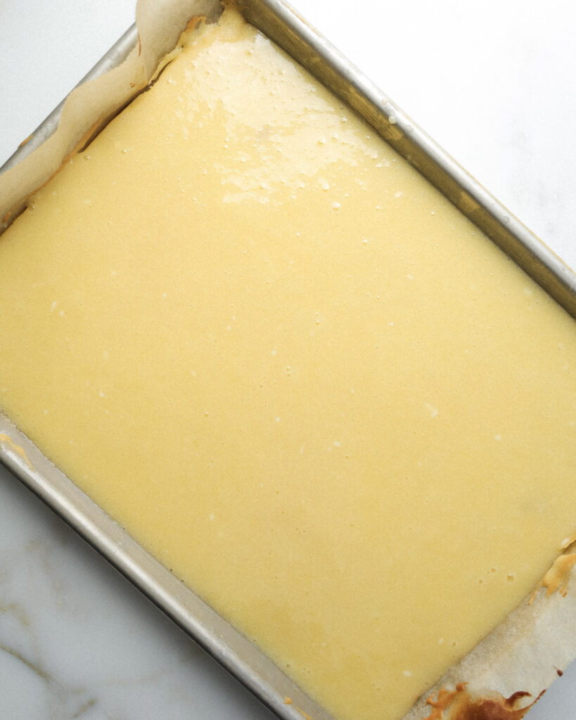 Gooey butter layer poured on top of the yellow cake layer.