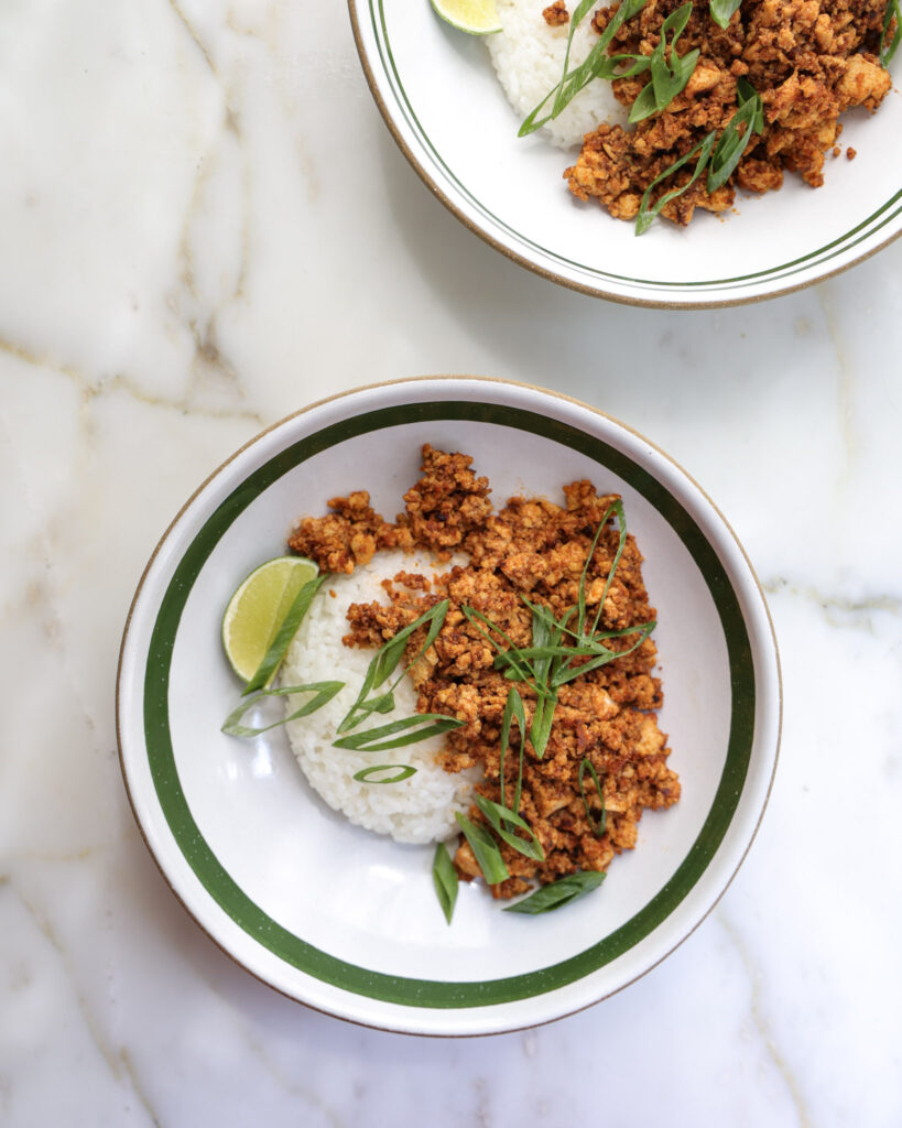 gochujang tofu over rice and topped with scallions.