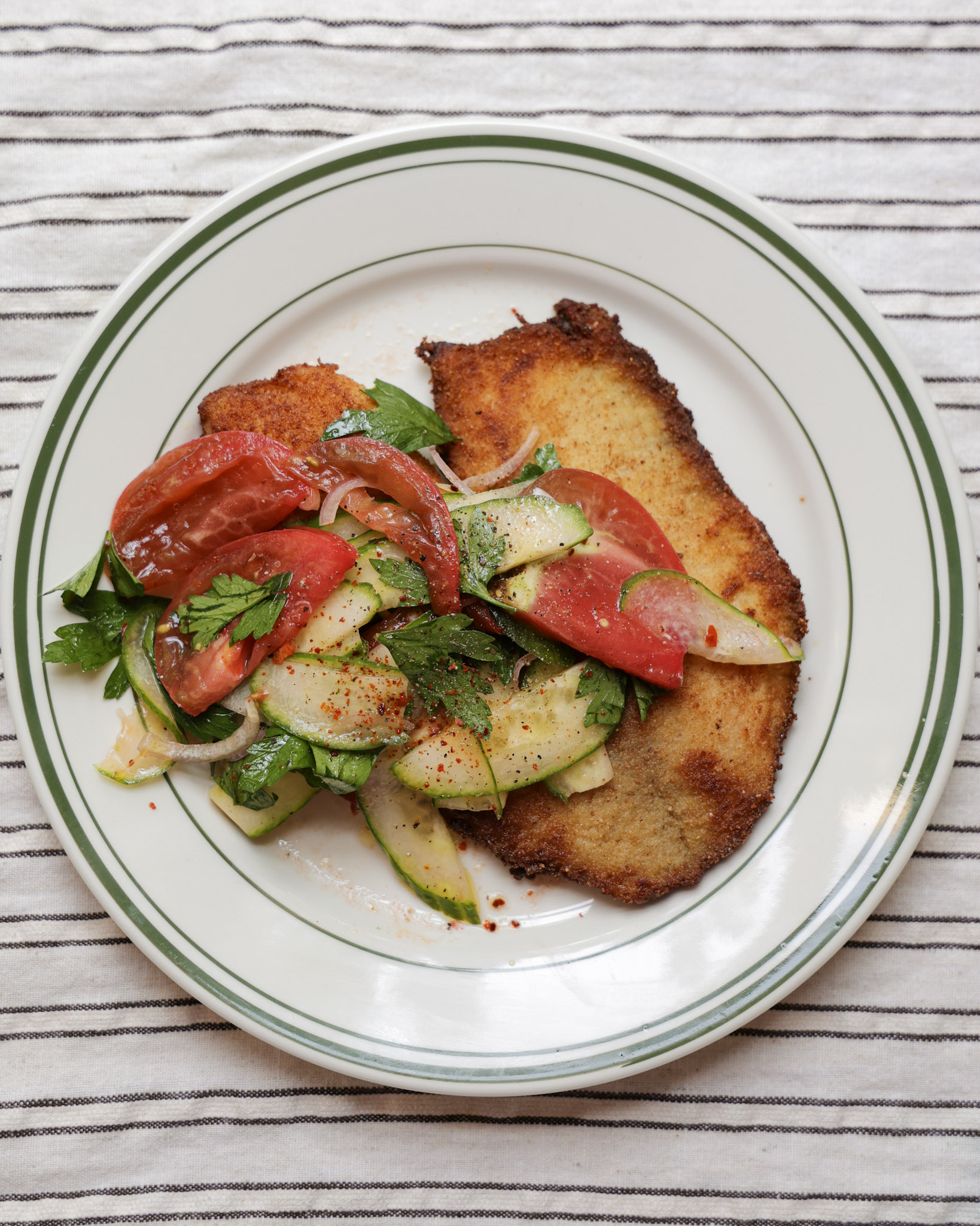 Tomato salad over fried fish.