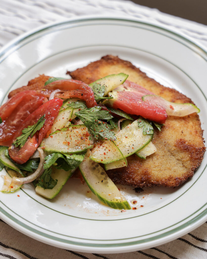 Tomato salad spooned over fried tilapia.