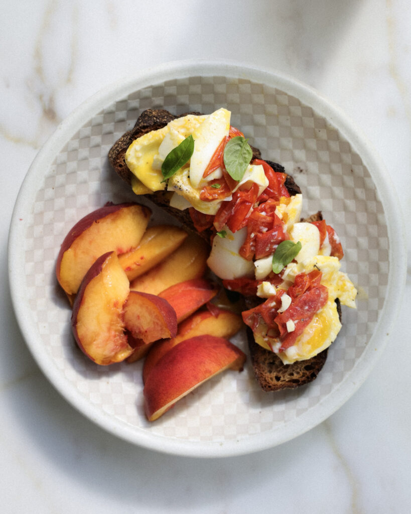 Pickled tomato skins on top of jammy eggs.
