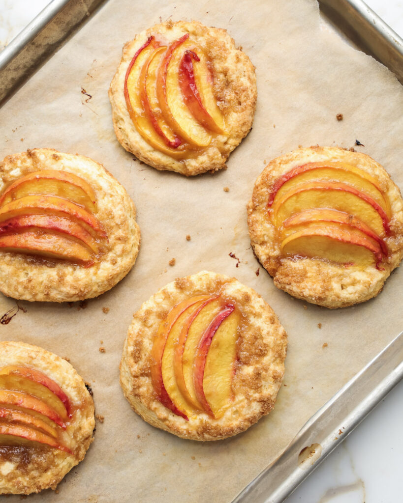 Baked shortcakes topped with peaches.