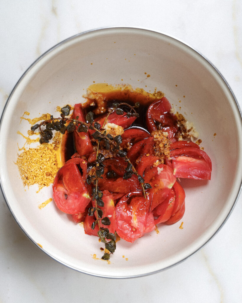 Tomatoes with paprika-infused olive oil poured over top.