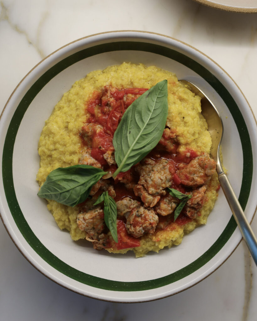 Fresh polenta & tomato sausage in a bowl.